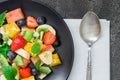 Fresh fruit salad on black plate. Top view Royalty Free Stock Photo