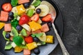 Fresh fruit salad on black plate. Top view Royalty Free Stock Photo