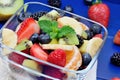 Fresh fruit salad in a bowl on blue wooden table Royalty Free Stock Photo