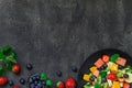 Fresh fruit salad on dark background. Top view, copy space Royalty Free Stock Photo