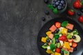 Fresh fruit salad on dark background. Top view, copy space Royalty Free Stock Photo