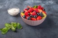 Fresh fruit salad with different ingredients with mint and sour cream on dark background. Healthy diet. Copy space for Royalty Free Stock Photo