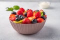 Fresh fruit salad with different ingredients with mint and sour cream. Healthy diet. Copy space for text. Close up Royalty Free Stock Photo