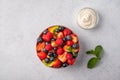 Fresh fruit salad with different ingredients with mint and sour cream. Healthy diet. Copy space for text. Top view Royalty Free Stock Photo