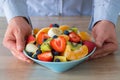Fresh Fruits Salad, The man holds a plate full of sliced fruit Royalty Free Stock Photo