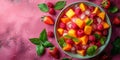 Fresh fruit salad with mango, raspberry, and strawberry garnished with basil, perfect for healthy eating themes. Royalty Free Stock Photo