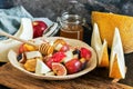 Fresh fruit salad melon, figs, apples, plums and honey. Selective focus. Royalty Free Stock Photo