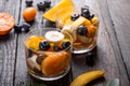 Fresh fruit salad with various kind of berry and citrus fruit, mango served in glass bowl, placed on wooden table. Shot from Royalty Free Stock Photo