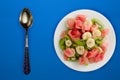 Fresh fruit salad on white plate on background. healthy food top view Royalty Free Stock Photo