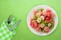 Fresh fruit salad on white plate on background. healthy food top view Royalty Free Stock Photo