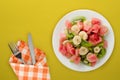 Fresh fruit salad on white plate on background. healthy food top view Royalty Free Stock Photo