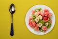 Fresh fruit salad on white plate on background. healthy food top view Royalty Free Stock Photo