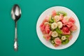 Fresh fruit salad on white plate on background. healthy food top view Royalty Free Stock Photo