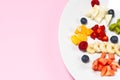 Fresh fruit salad on white plate. Mixed fruit in white plate healthy food style. Useful fruit salad of fresh fruits and Royalty Free Stock Photo