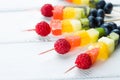 Fresh fruit shish kebabs arranged diagonally for a healthy vegetarian buffet Royalty Free Stock Photo