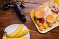 Fresh fruit smoothie with banana and apricots at orange  tray  with blender  at wooden table. flat lay Royalty Free Stock Photo