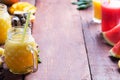 Fresh fruit smoothie and pieces of fruits on a dark wooden rustic background Royalty Free Stock Photo