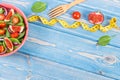 Fresh fruit and vegetable salad, fork with tape measure, slimming and nutrition concept, copy space for text Royalty Free Stock Photo