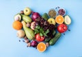 Fresh fruit and vegetables in heart shape top view flat lay on blue background Royalty Free Stock Photo