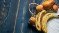 Fresh fruit on a white wooden tray: banatas, pears, apricots. Countryside setting. Top view. Royalty Free Stock Photo