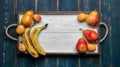 Fresh fruit on a white wooden tray: banatas, pears, apricots. Countryside setting. Top view. Royalty Free Stock Photo