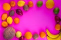 Fresh fruitage on pink background. Coconut, orange, limes