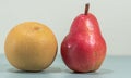 Fresh fruits of Asian pear Pyrus pyrifolia and Red pear Pyrus communis `Williams` on blue background Royalty Free Stock Photo