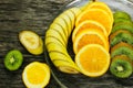 Fresh fruits banana, kiwi, orange on wooden background. Healthy food. A mix of fresh fruit. Group of citrus fruits. Vegetarian raw Royalty Free Stock Photo