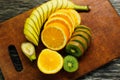 Fresh fruits banana, kiwi, orange on wooden background. Healthy food. A mix of fresh fruit. Group of citrus fruits. Vegetarian raw Royalty Free Stock Photo