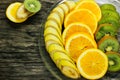 Fresh fruits banana, kiwi, orange on wooden background. Healthy food. A mix of fresh fruit. Group of citrus fruits. Vegetarian raw Royalty Free Stock Photo