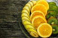 Fresh fruits banana, kiwi, orange on wooden background. Healthy food. A mix of fresh fruit. Group of citrus fruits. Vegetarian raw Royalty Free Stock Photo