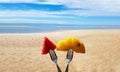 Fresh Fruits on the beach on fork in front of an island. Assorted tropical fruits, pineapple and watermelon piece