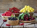 Fresh fruits and berries in the basket on wooden background Royalty Free Stock Photo