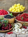 Fresh fruits and berries in the basket on wooden background Royalty Free Stock Photo