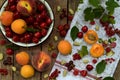 Fresh fruits and berries on wooden background. Ripe sweet cherry, currants, peach and apricot, mulberry on the kitchen table. Royalty Free Stock Photo