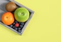 Fresh fruits and berries in a wooden tray. Royalty Free Stock Photo