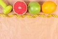 Fresh fruits, centimeter and dumbbells for fitness, concept of healthy lifestyles Royalty Free Stock Photo