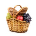 Fresh fruits grapes, apples in willow basket with lid isolated Royalty Free Stock Photo