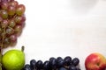 Fresh fruits grapes, pear and apple on wooden boards frame background. Royalty Free Stock Photo