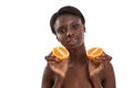 Fresh fruits for healthy skin. Portrait of beautiful young african woman with healthy skin holding two pieces of orange Royalty Free Stock Photo