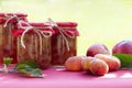 Fresh fruits and homemade jars of jam on natural background. Preserves of peaches, nectarines Royalty Free Stock Photo