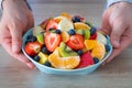 Fresh Fruits Salad, The man holds a plate full of sliced fruit Royalty Free Stock Photo