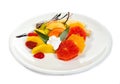 Fresh fruits salad on plate isolated on white Royalty Free Stock Photo