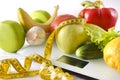 Fresh fruits and vegetables, dumbbell, are placed  measuring tape  on white electronic scales Royalty Free Stock Photo