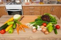 Fresh fruits and vegetables on the table in kitchen interior, healthy food concept Royalty Free Stock Photo