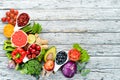 Fresh fruits and vegetables on a white wooden background. Top view. Royalty Free Stock Photo