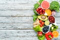 Fresh fruits and vegetables on a white wooden background. Top view. Royalty Free Stock Photo