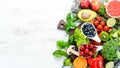 Fresh fruits and vegetables on a white wooden background. Top view. Royalty Free Stock Photo