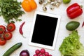 Fresh fruits and vegetables wirh tablet on a white wooden background, top view. Flat lay. Royalty Free Stock Photo