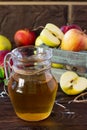 Fresh fruity apple juice and ripe apples on a wooden table. The concept of nutrition for superfoods and health or detoxification